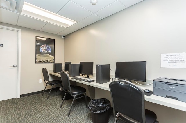 carpeted office space featuring a paneled ceiling