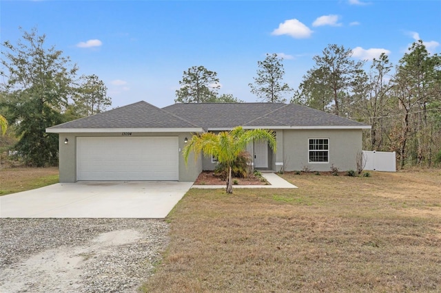 ranch-style house featuring a garage, a front yard, concrete driveway, and stucco siding