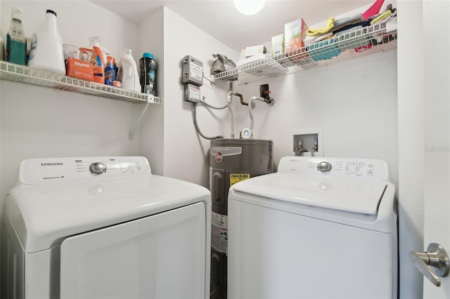 clothes washing area featuring washer and dryer and electric water heater