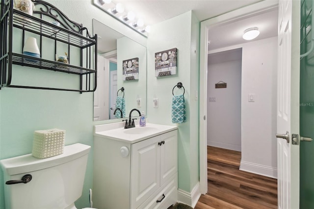 bathroom featuring vanity, toilet, and wood-type flooring