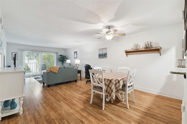 dining room with ceiling fan and light hardwood / wood-style flooring