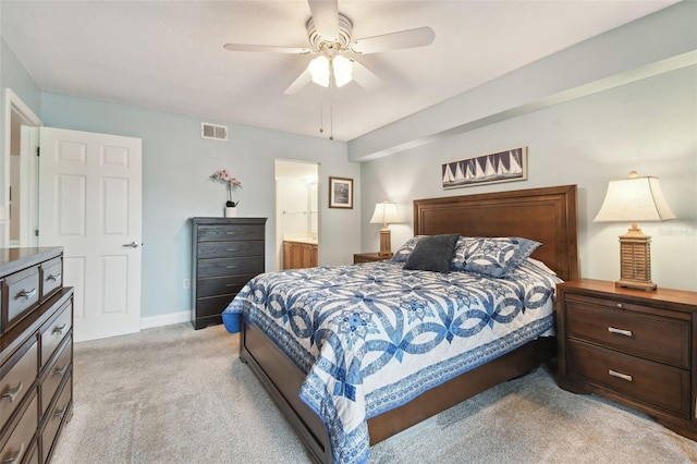 carpeted bedroom with ceiling fan and ensuite bath