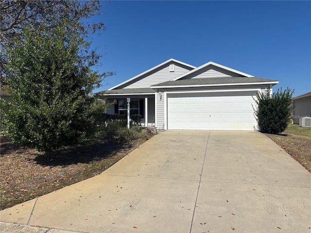 single story home featuring concrete driveway, an attached garage, and cooling unit