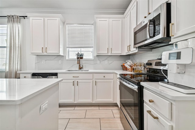 kitchen featuring white cabinetry, appliances with stainless steel finishes, and sink