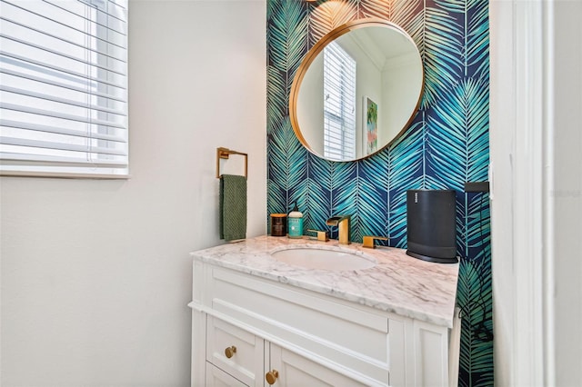 bathroom with vanity, crown molding, and plenty of natural light