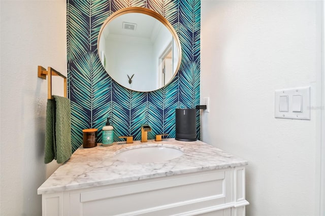 bathroom with vanity and crown molding