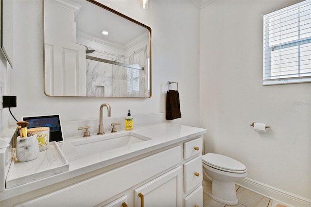 bathroom with vanity, ornamental molding, toilet, and walk in shower