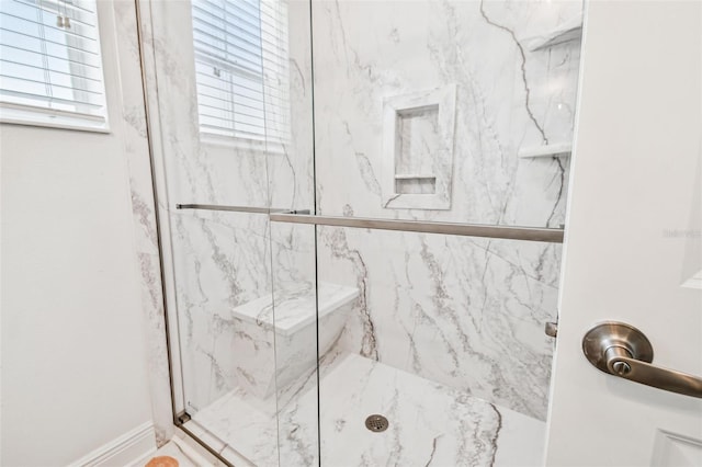 bathroom featuring a shower with shower door