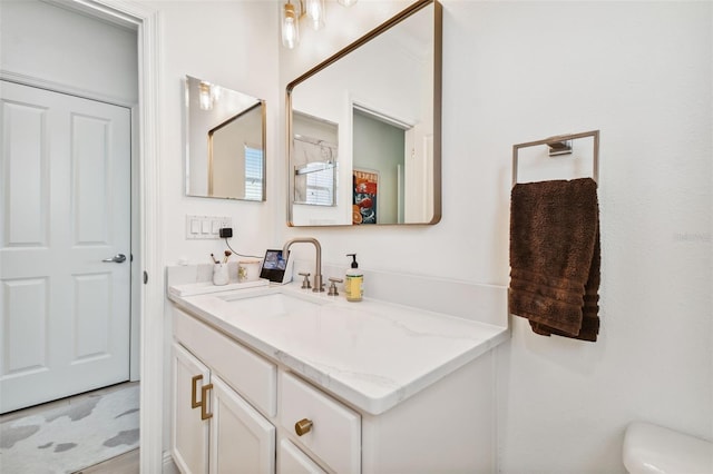 bathroom with vanity and toilet