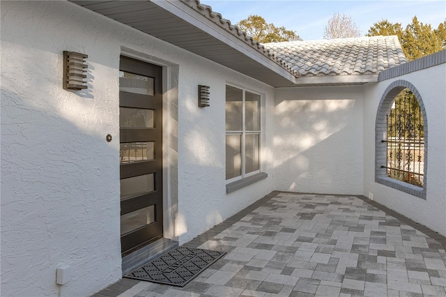 doorway to property with a patio area