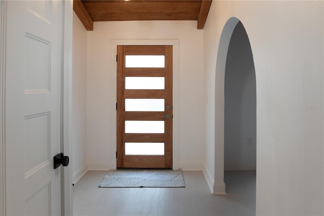 entryway featuring wood ceiling, light hardwood / wood-style flooring, and beamed ceiling