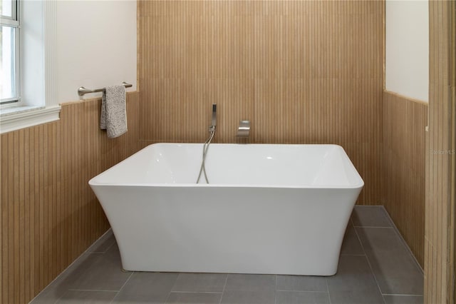 bathroom featuring tile patterned flooring and a bathtub