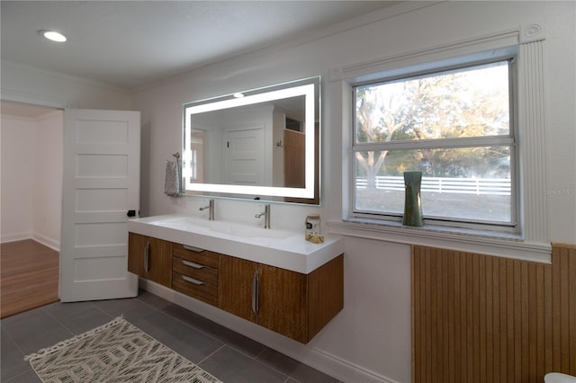 bathroom with vanity, ornamental molding, and tile patterned floors