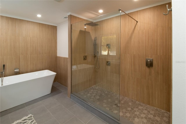 bathroom featuring tile patterned flooring, crown molding, and plus walk in shower