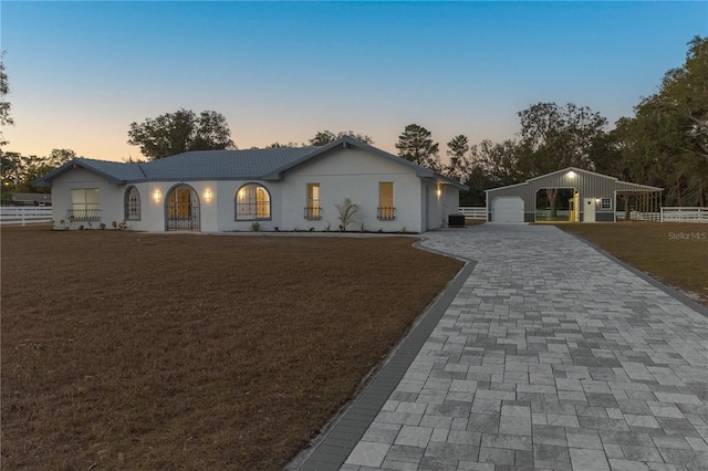 single story home with a yard and a garage