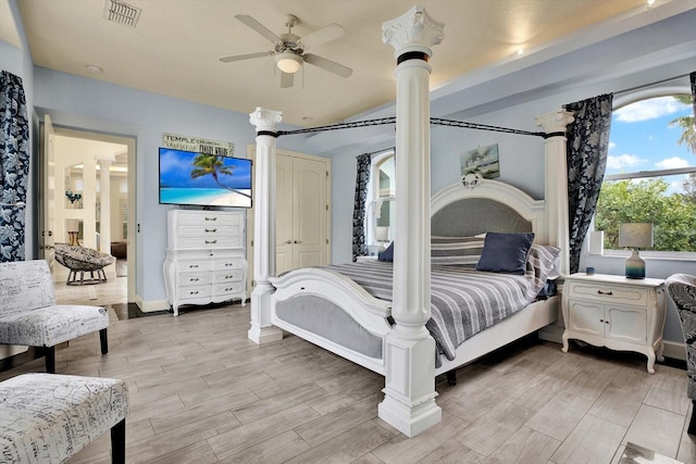 bedroom featuring decorative columns and ceiling fan