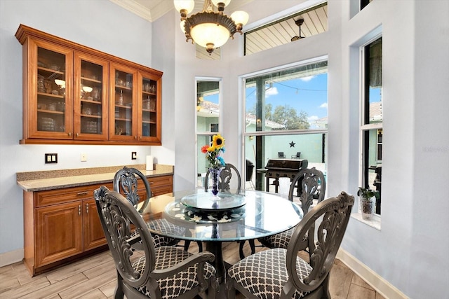 dining area featuring ornamental molding and a chandelier