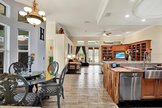 kitchen with dishwasher, sink, crown molding, and french doors