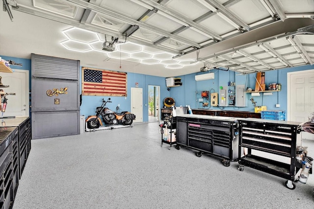 garage with a garage door opener, a wall mounted AC, and a workshop area