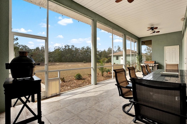 sunroom / solarium featuring ceiling fan