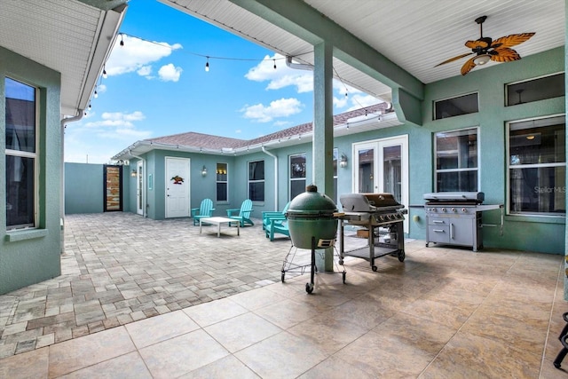 view of patio with ceiling fan and a grill