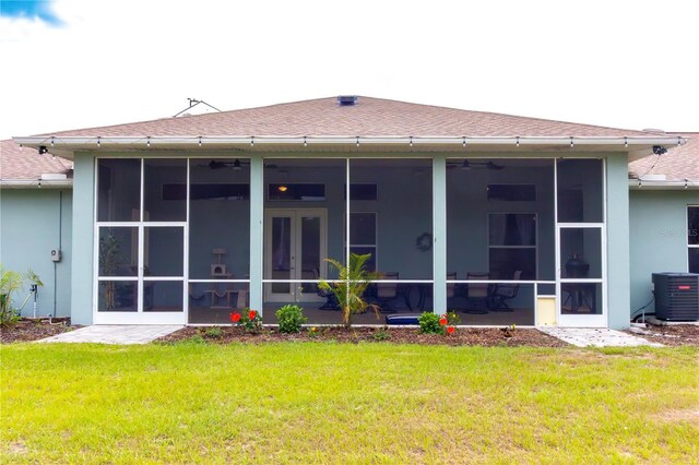 10030 Orchard Way, Spring Hill, FL 34608 - rear view of house with a sunroom, central AC, roof with shingles, and a yard