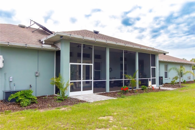 10030 Orchard Way, Spring Hill, FL 34608 - back of property featuring roof with shingles, a yard, a sunroom, stucco siding, and ceiling fan