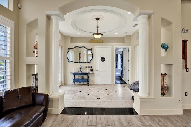 10030 Orchard Way, Spring Hill, FL 34608 - entrance foyer featuring ornate columns, wood finished floors, and baseboards