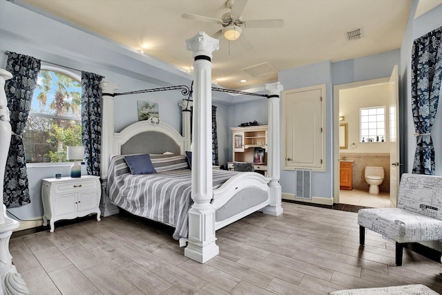 10030 Orchard Way, Spring Hill, FL 34608 - bedroom featuring attic access, light wood finished floors, baseboards, connected bathroom, and a ceiling fan