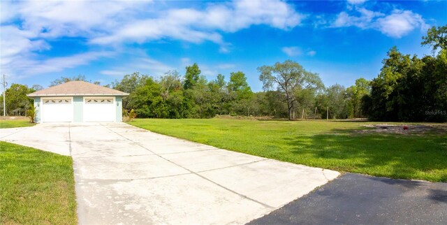 10030 Orchard Way, Spring Hill, FL 34608 - view of grassy yard with a detached garage