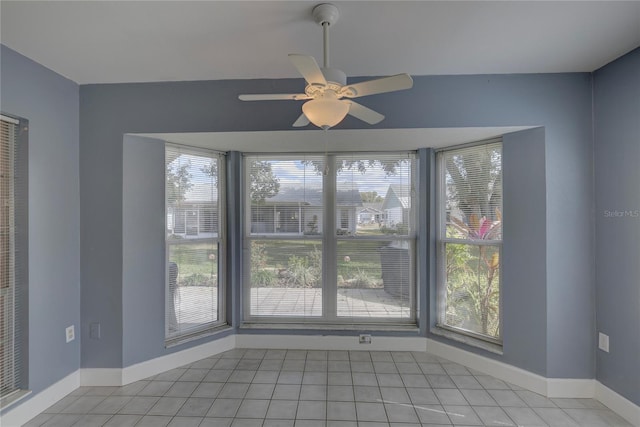 spare room featuring light tile patterned floors and ceiling fan