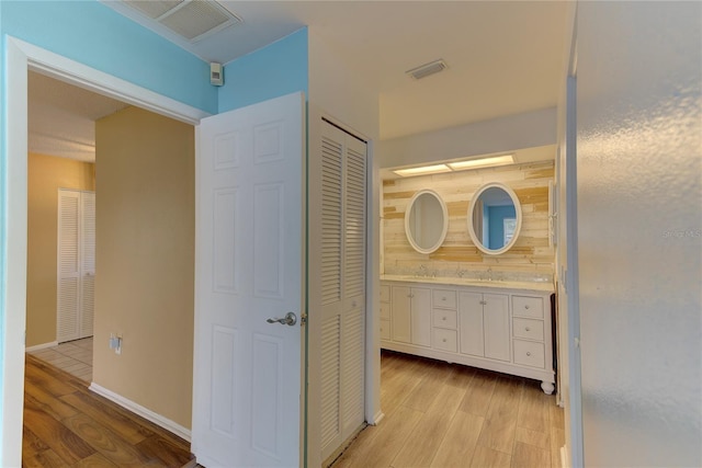 bathroom with vanity and wood-type flooring