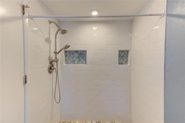 bathroom with a tile shower