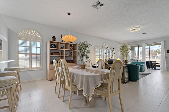 dining space featuring a textured ceiling