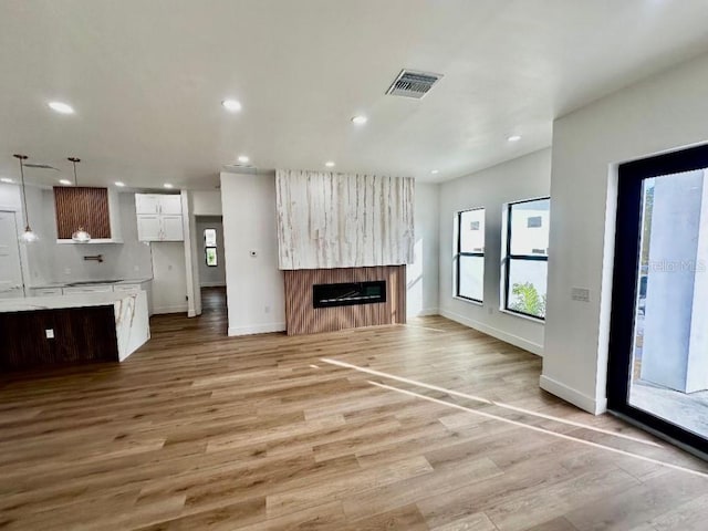 unfurnished living room with light hardwood / wood-style flooring