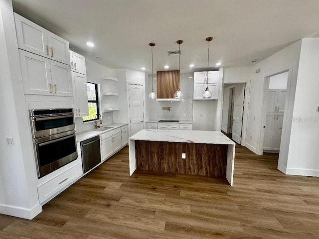 kitchen with a kitchen island, tasteful backsplash, dishwasher, sink, and white cabinets