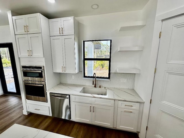 kitchen with white cabinetry, stainless steel appliances, and sink