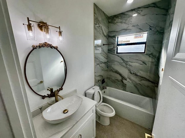 full bathroom with tiled shower / bath, vanity, toilet, and tile patterned floors