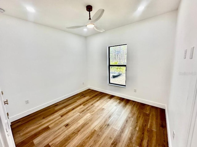 empty room featuring hardwood / wood-style flooring and ceiling fan