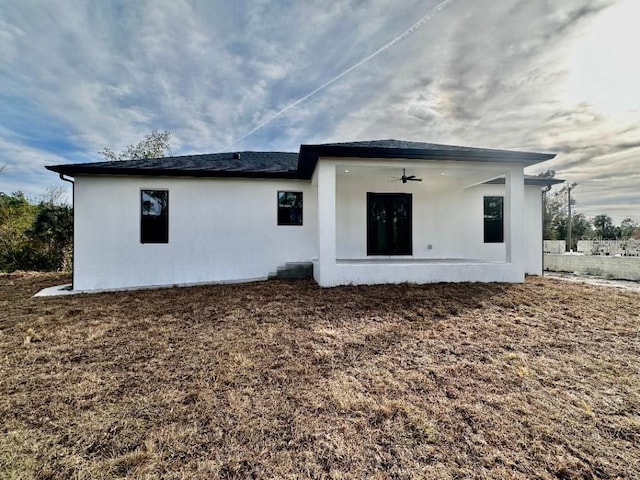 rear view of house with ceiling fan