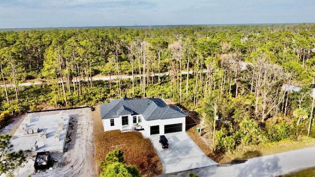 drone / aerial view featuring a view of trees