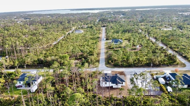 birds eye view of property featuring a view of trees