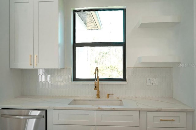 kitchen featuring open shelves, stainless steel dishwasher, a sink, and white cabinetry