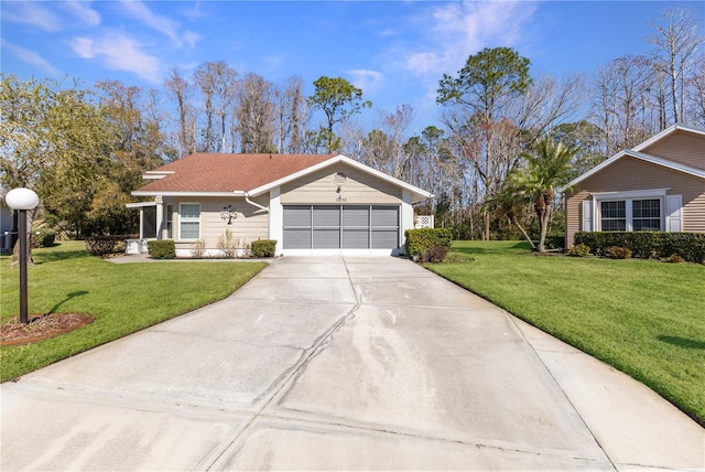 ranch-style home with a garage and a front lawn