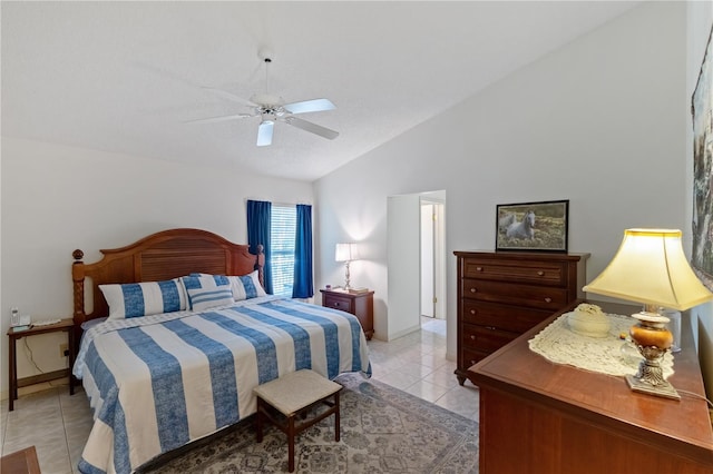 bedroom featuring ceiling fan, lofted ceiling, and light tile patterned floors