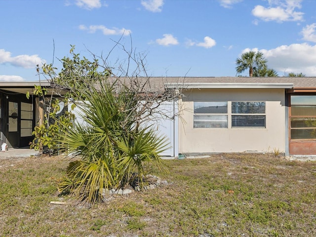 view of side of property with a yard