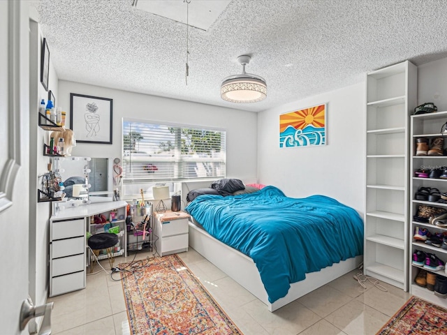 tiled bedroom with a textured ceiling