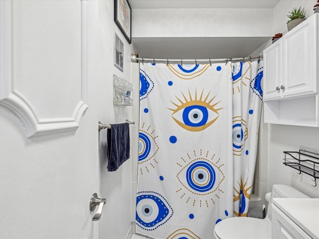 bathroom with toilet and a shower with shower curtain