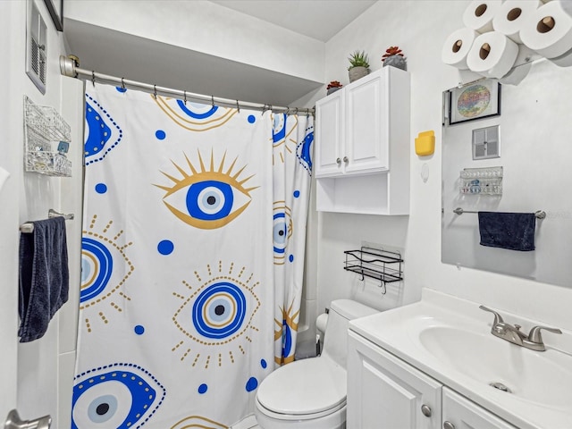 bathroom featuring vanity, toilet, and walk in shower