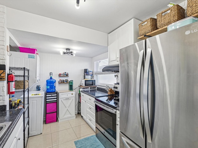 kitchen featuring stainless steel appliances, white cabinets, and light tile patterned flooring